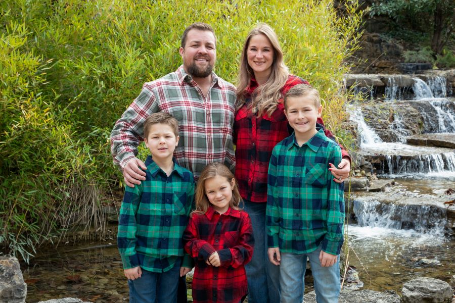 Family in festive attire posing for family portrait