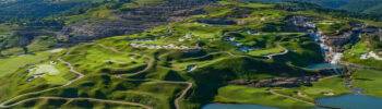 A beautiful golf course built on a beautiful hillside featuring waterfalls, ponds, winding cart paths, and uniquely shaped bunkers