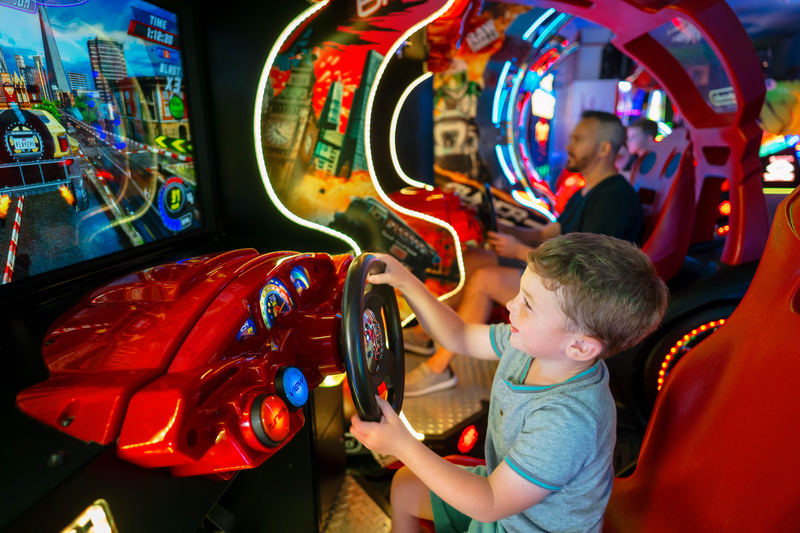 Father and Son Playing a racing game in the arcade