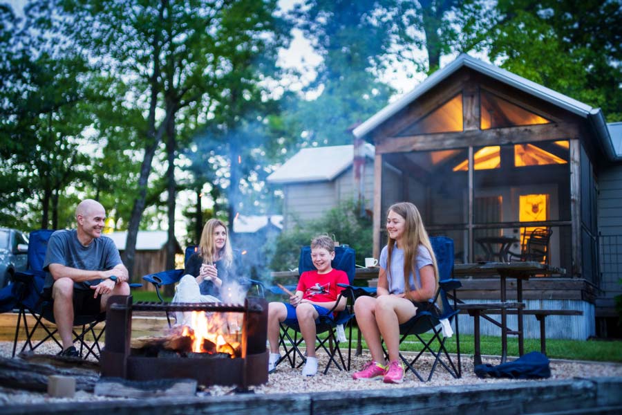 Family around a campfire at Camp Long Creek