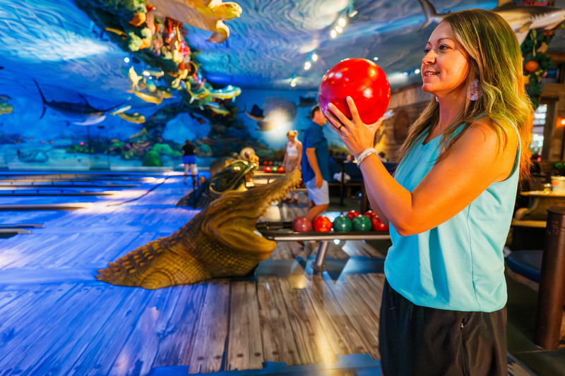Mother readying to roll a bowling ball