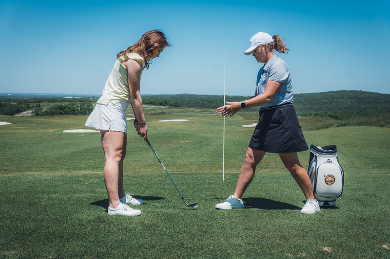 A golfer receives 1 on 1 training from a professional golf teacher