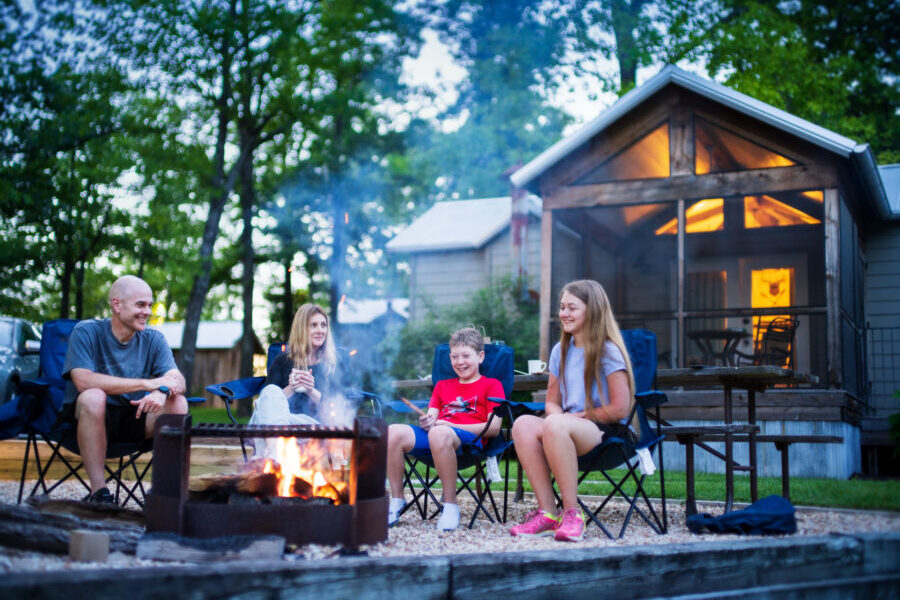 Family sits around a fire pit