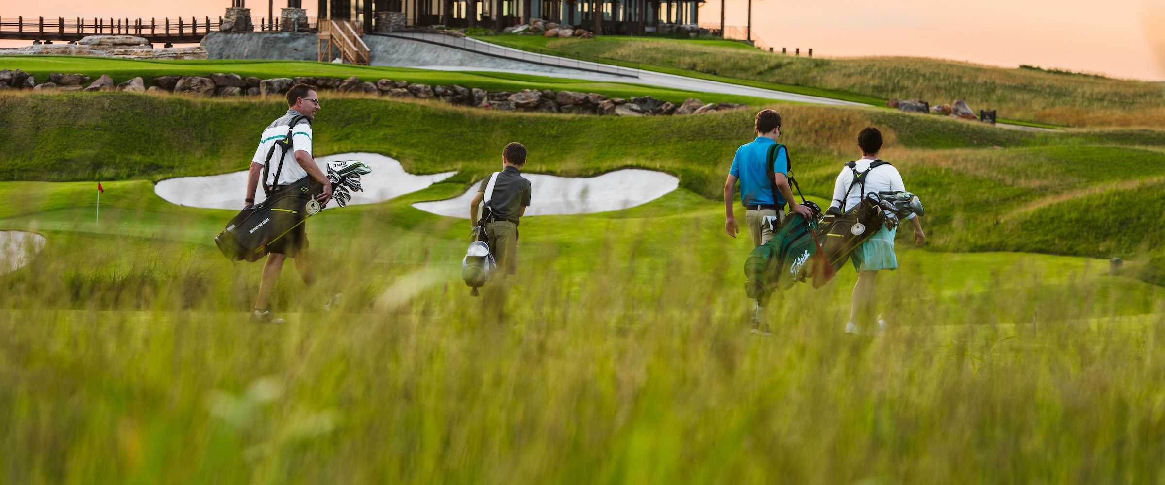 A father and his 3 sons play golf at Mountain Top Golf Course at Big Cedar Lodge