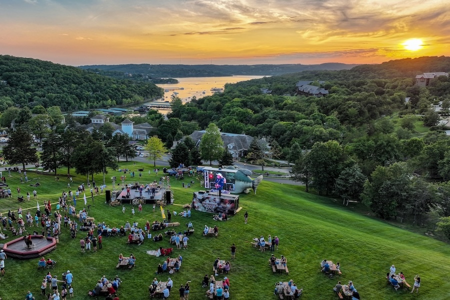 Areal shot of a picnic at sunset on the Grandview Conference Center lawn with inflatables, live music, and picnic food.