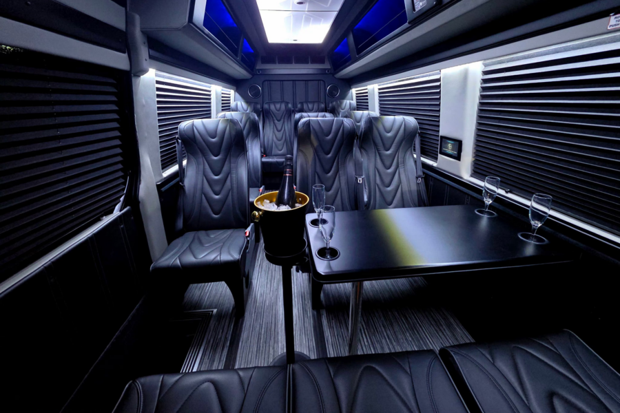 A luxurious interior private shuttle with a chilled bottle of champagne for the passengers.