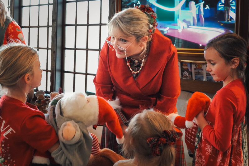 Mrs. Claus and children making stuffed animals.