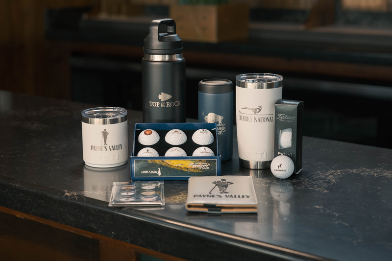 A collection of golf merchandise that is branded with Big Cedar Golf Course logos