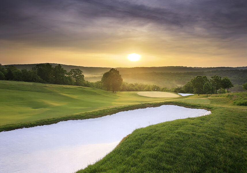 sunset over buffalo ridge fariway and sand bunker