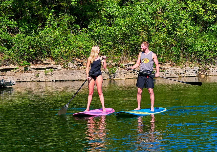 couple enjoy the lake on stand-up paddleboards
