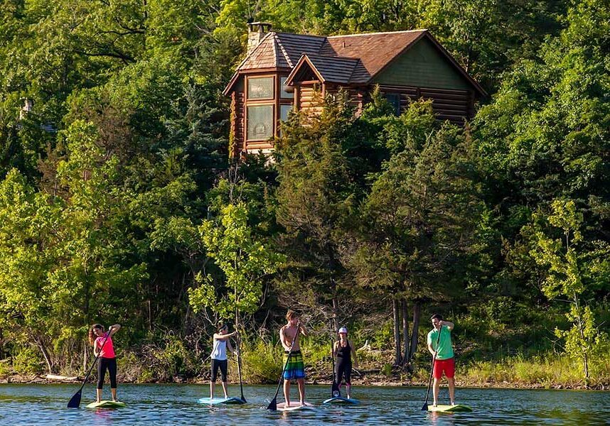 group of people on lake on stand-up paddleboards