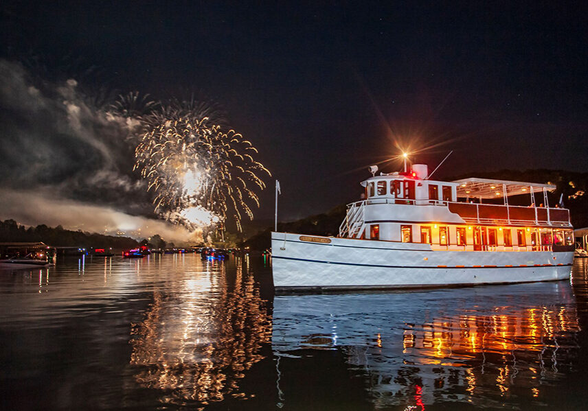 lady liberty sits on table rock lake watching fireworks