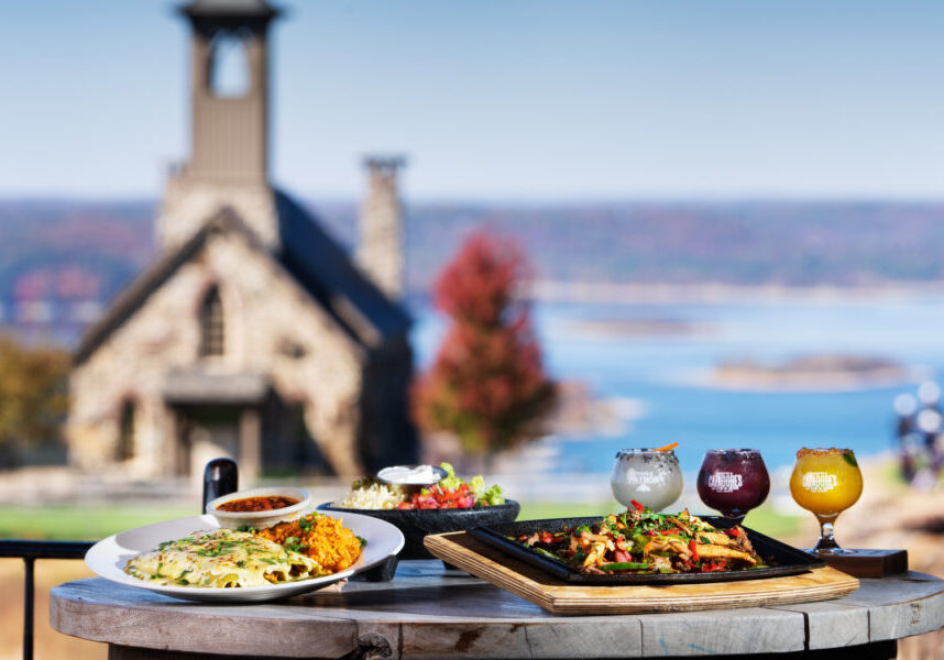 table set with food and drinks at top of the rock at big cedar lodge
