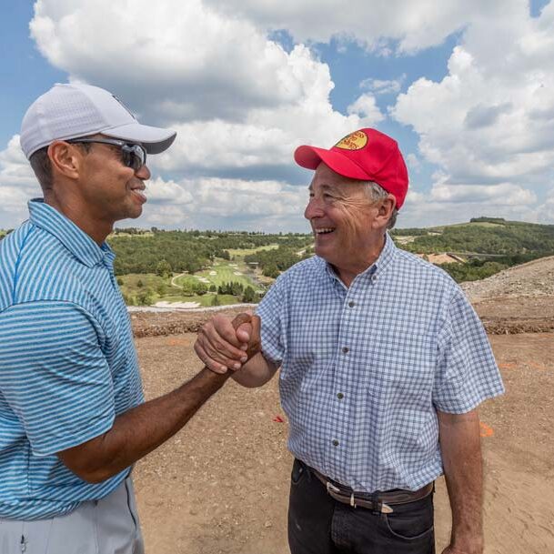 Johhny Morris and Tiger Woods great each other at Payne's Valley