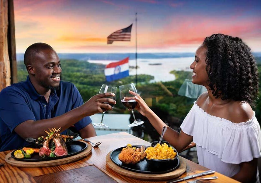 A couple makes a toast over dinner at Osage Restaurant, just as the sun dips below the horizon