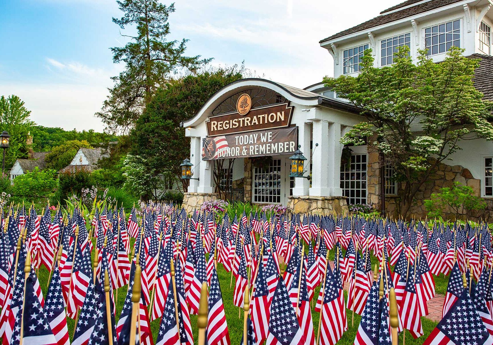 Big Cedar Lodge registration building with American flags filling the yard