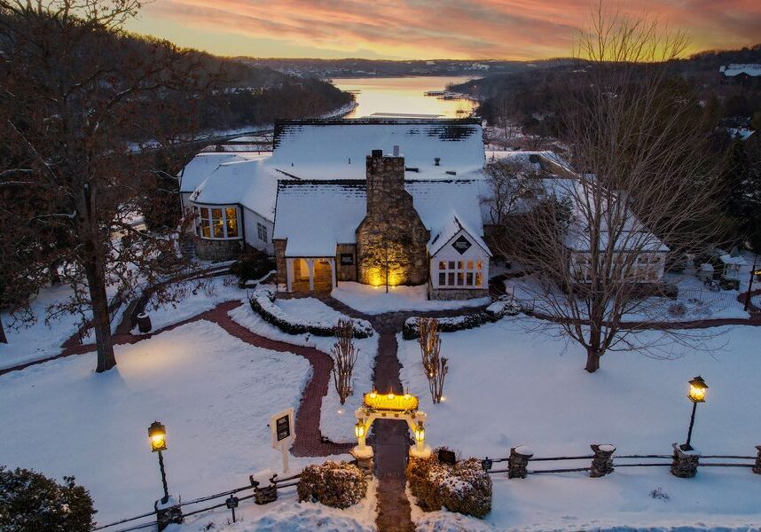 The sun sets over the snow-covered Worman House