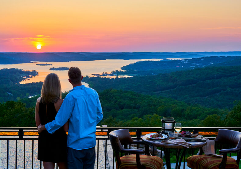 couple overlooking lake at sunset