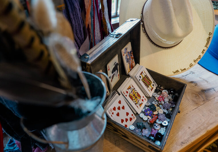 Charms, feathers, and strips of fabric for custom designed hats