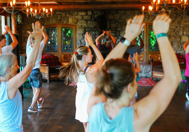 People in work out clothes with hands raised