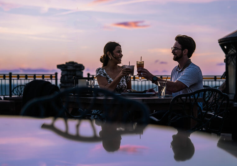 Couple toasting at Dust outdoors