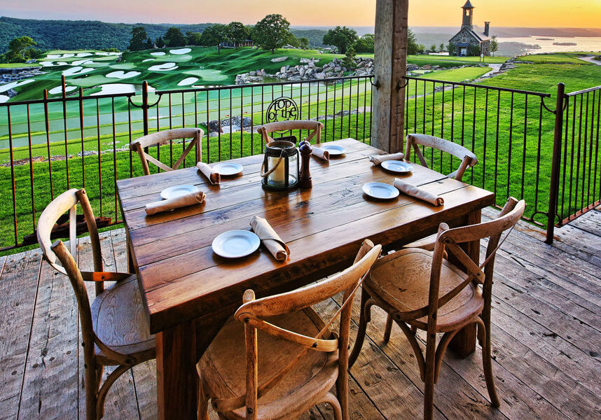 Arnies Barn Casual Dining at Top of the Rock at Big Cedar Patio table setting at Arnie's Barn casual dining with view Top of the Rock chapel and golf course at Big Cedar