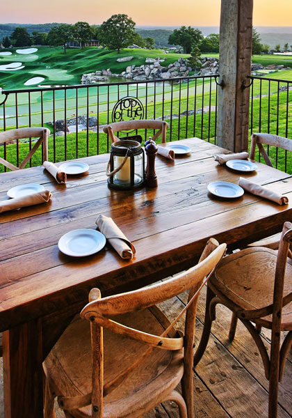 Patio table setting at Arnie's Barn casual dining with view Top of the Rock chapel and golf course at Big Cedar