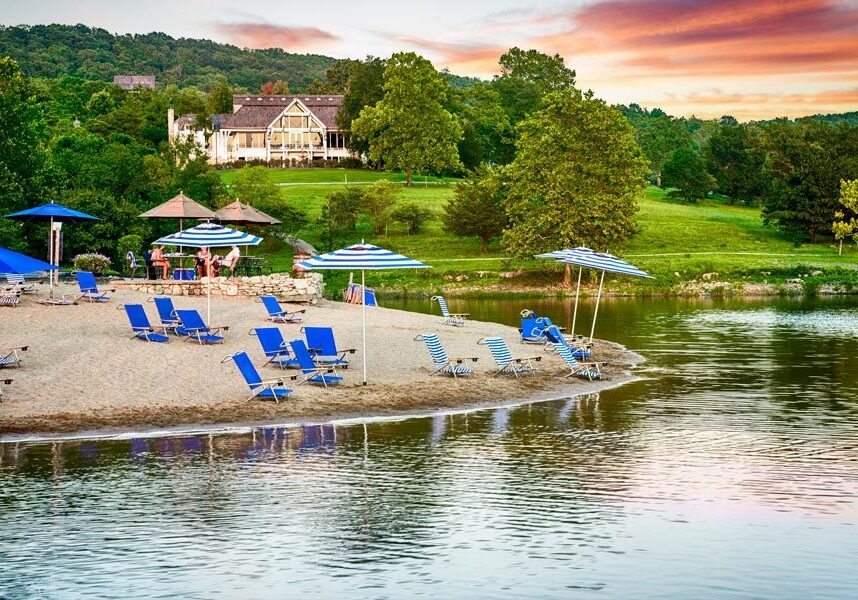 Beach chairs and umbrellas in the sand at Bent Hook Marina beach at Big Cedar