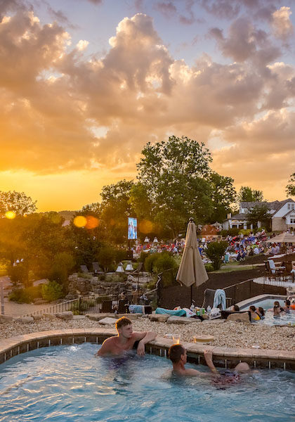 Two pools at Big Cedar Lodge with the sunset on the horizon