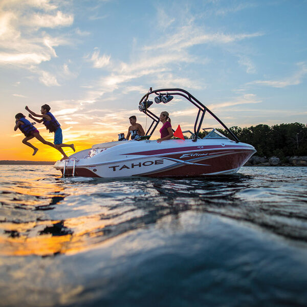 Family jumping into water from a rented boat on Table Rock Lake at Big Cedar