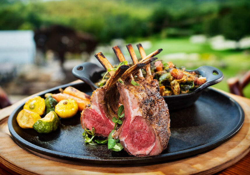 A plate of a rack of lamb and vegetables on the side, from the Osage Restaurant at Big Cedar Lodge.