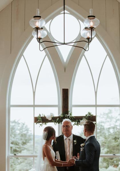Couple exchanging wedding vows at the Garden Chapel at Big Cedar