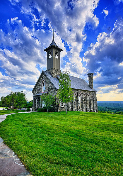 Chapel of the Ozarks with vivid clouds above and Table Rock Lake below