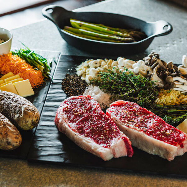 Steak, asparagus, stuffed baked potato and salad as part of the Backyard Basket at Big Cedar dining and room service