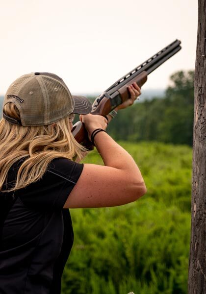 Woman shooting clays at Bass Pro Shops Shooting Academy at Big Cedar