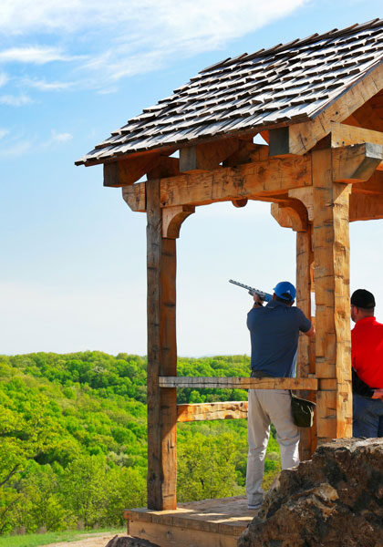 Man being trained on shooting at Bass Pro Shops Shooting Academy at Big Cedar